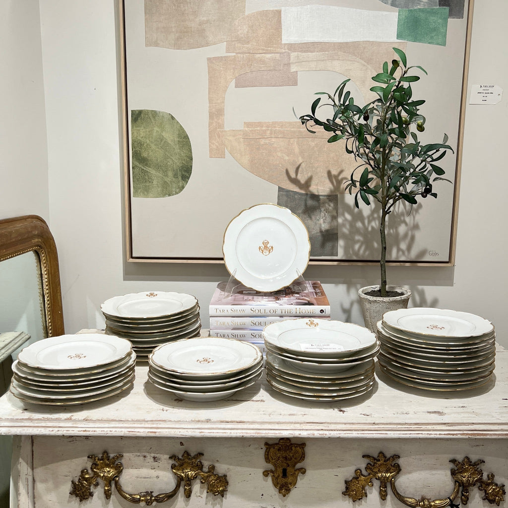Antique dessert and salad plate set with gold MS monogram and scalloped edges displayed on a rustic table.