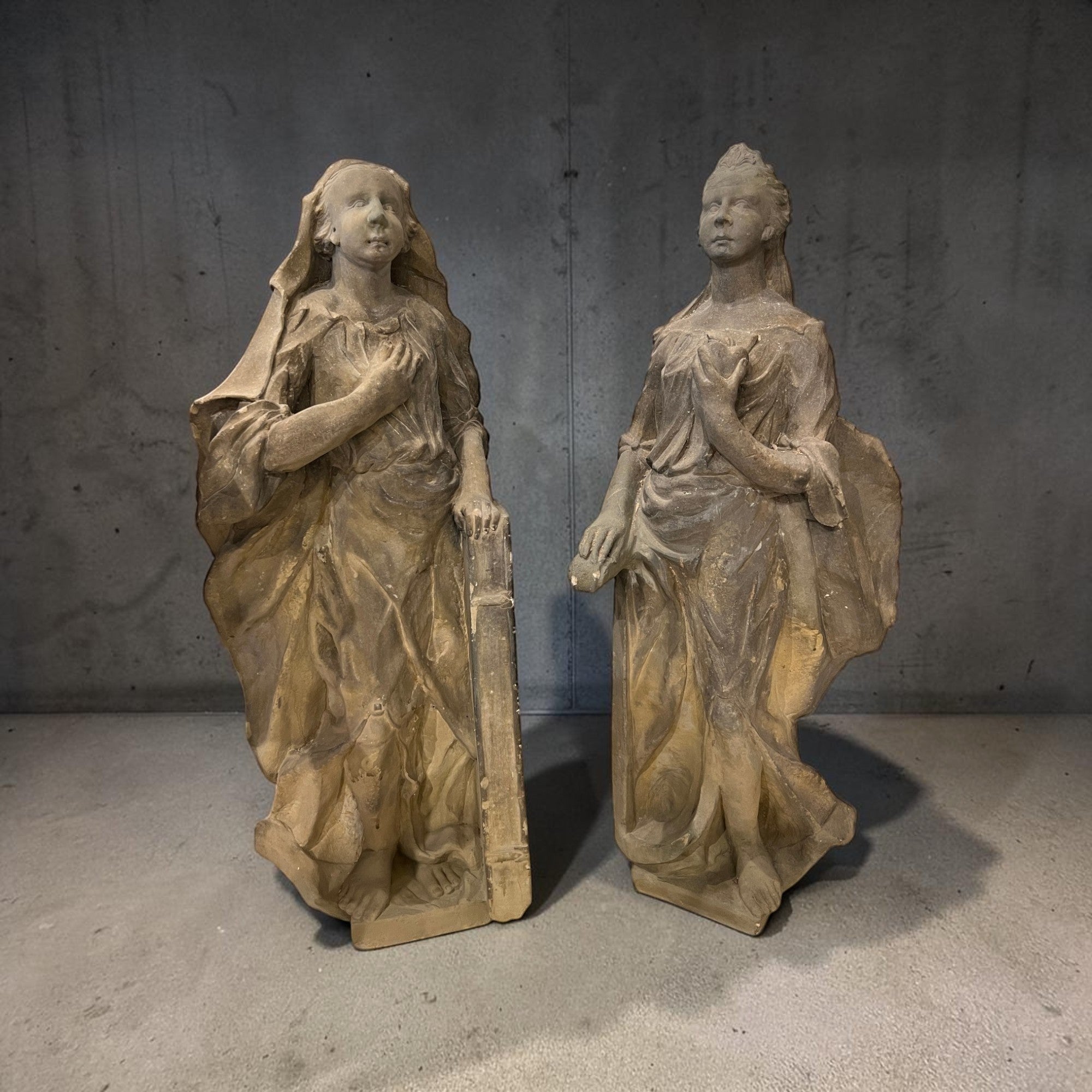 Tara Shaw pair of 18th century German stone statues featuring weathered female figures with classical sculptural detail.