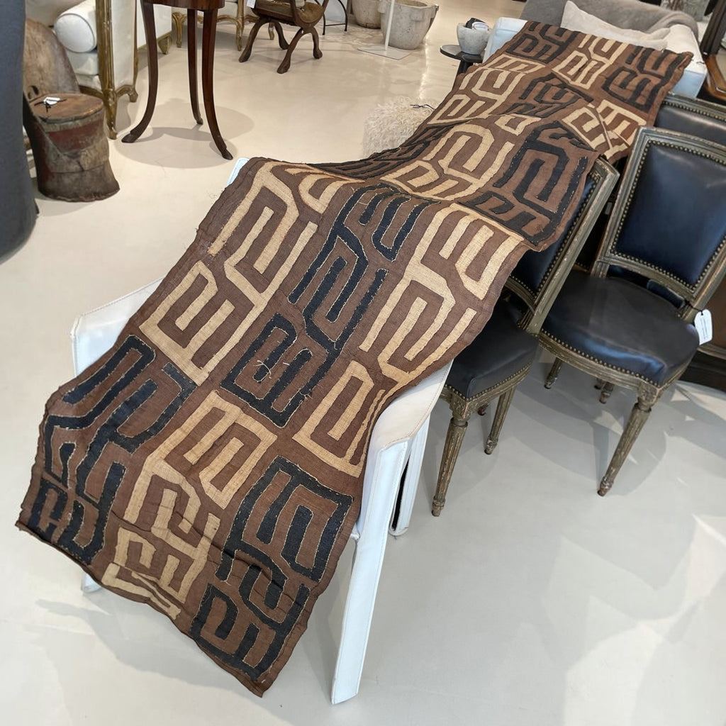 Tara Shaw African Kuba cloth long runner featuring handwoven geometric patterns in earthy brown and black tones.