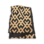 Tara Shaw African Kuba cloth long runner with intricate black and tan geometric patterns and handwoven texture.