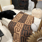 Tara Shaw authentic African Kuba cloth runner with intricate geometric patterns in earthy brown and black tones.