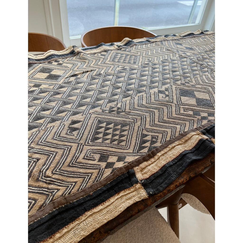 Tara Shaw authentic African Kuba cloth runner with intricate geometric patterns in earthy brown and black tones.