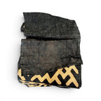 Tara Shaw authentic African Kuba cloth long runner featuring handwoven black and tan geometric patterns.