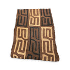 Tara Shaw authentic African Kuba cloth runner featuring intricate geometric patterns in earthy brown and black tones.