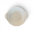 Tara Shaw 19th century European ironstone bowl with ornate handles and aged white patina, top-down view.