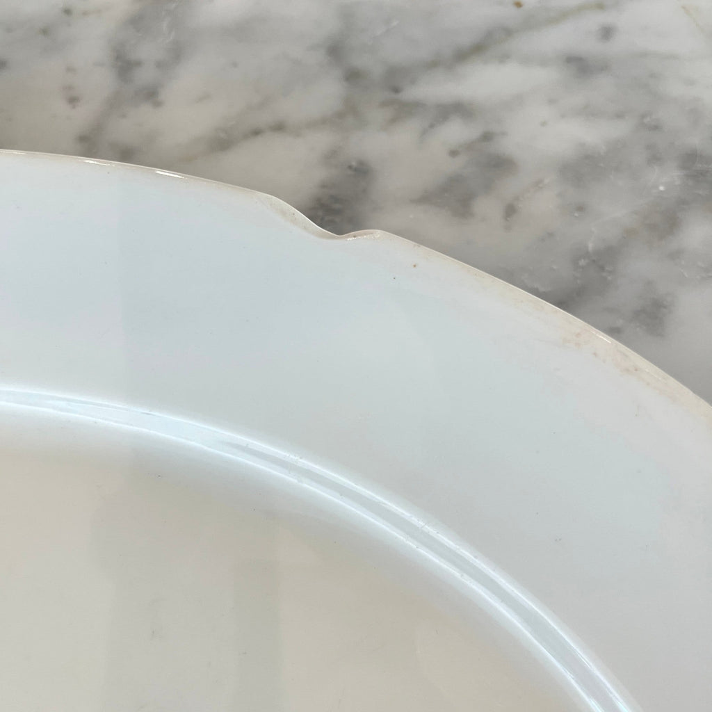 Tara Shaw antique white ironstone platter edge detail showing aged glaze and subtle patina on a marble surface