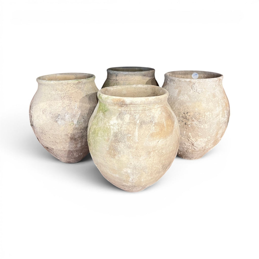Tara Shaw set of four rustic 18th-century Spanish pottery jars with unique timeworn patina and textured finish.