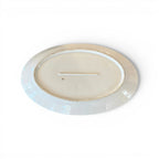Tara Shaw antique 19th century European white ironstone platter showing the underside with aged patina and markings.