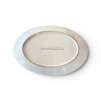 Tara Shaw 19th century antique white ironstone platter showing the underside with aged patina and oval shape