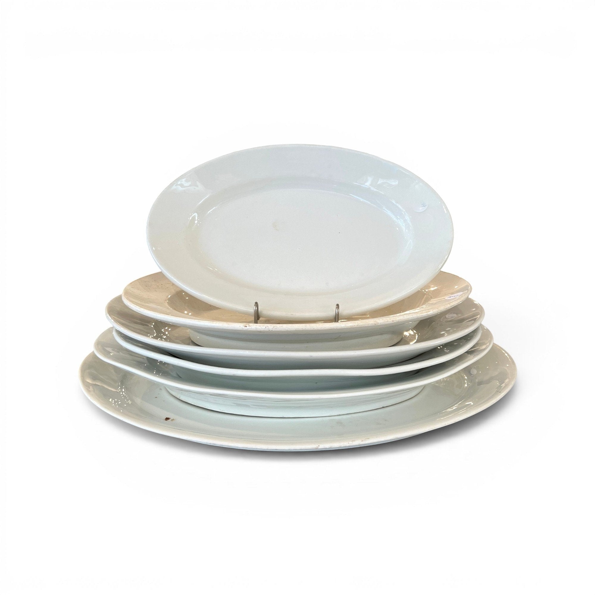 Tara Shaw collection of five assorted 19th century European antique white ironstone platters with aged patina