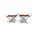 Tara Shaw pair of folding sword stools with argenté metal frames and brown leather seats in a campaign style.