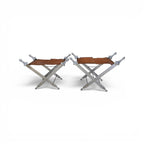 Tara Shaw pair of folding sword stools with argenté metal frames and brown leather seats in a campaign style.