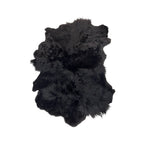 Tara Shaw black sheepskin rug with a textured high-low pile for a luxurious and modern interior accent.