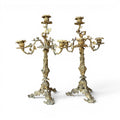 Tara Shaw pair of early 20th-century bronze candelabras with ornate sculptural leaf detailing and a rich patina.