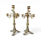 Tara Shaw pair of early 20th-century bronze candelabras with ornate sculptural detailing and a rich aged patina.