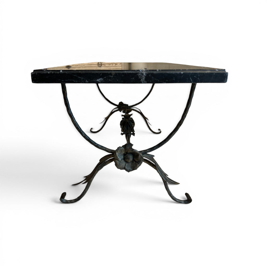 Tara Shaw bronze leaf base coffee table with a polished black marble top and intricate floral metal detailing.