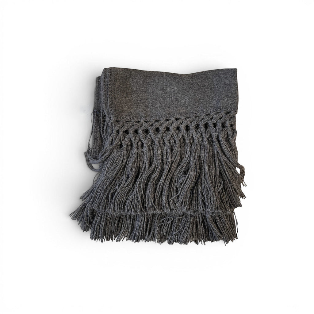 Tara Shaw dark grey alpaca bouclé throw blanket with decorative knotted fringe detail on a white background.