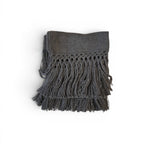 Tara Shaw dark grey alpaca bouclé throw blanket with decorative knotted fringe detail on a white background.