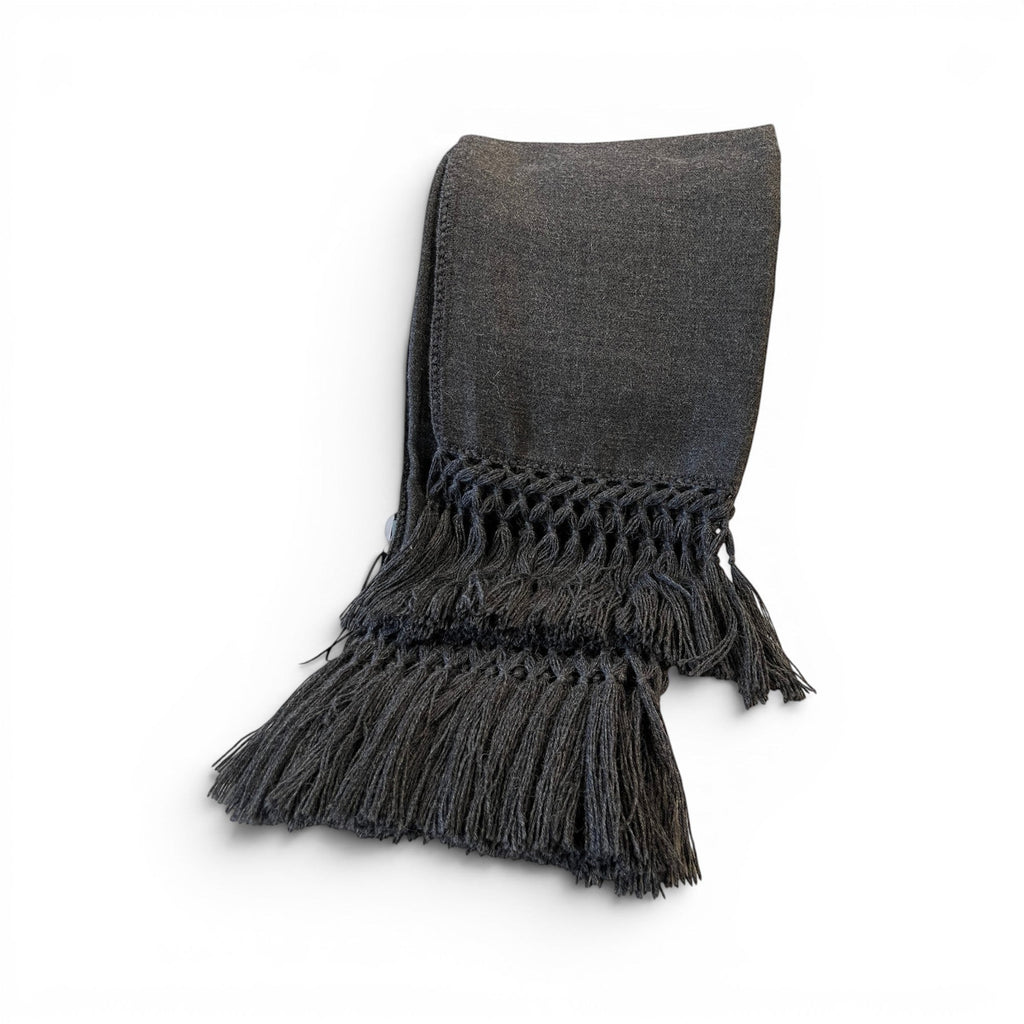 Tara Shaw dark grey alpaca bouclé throw blanket with decorative knotted fringe detail on a white background.