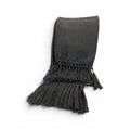 Tara Shaw dark grey alpaca bouclé throw blanket with decorative knotted fringe detail on a white background.