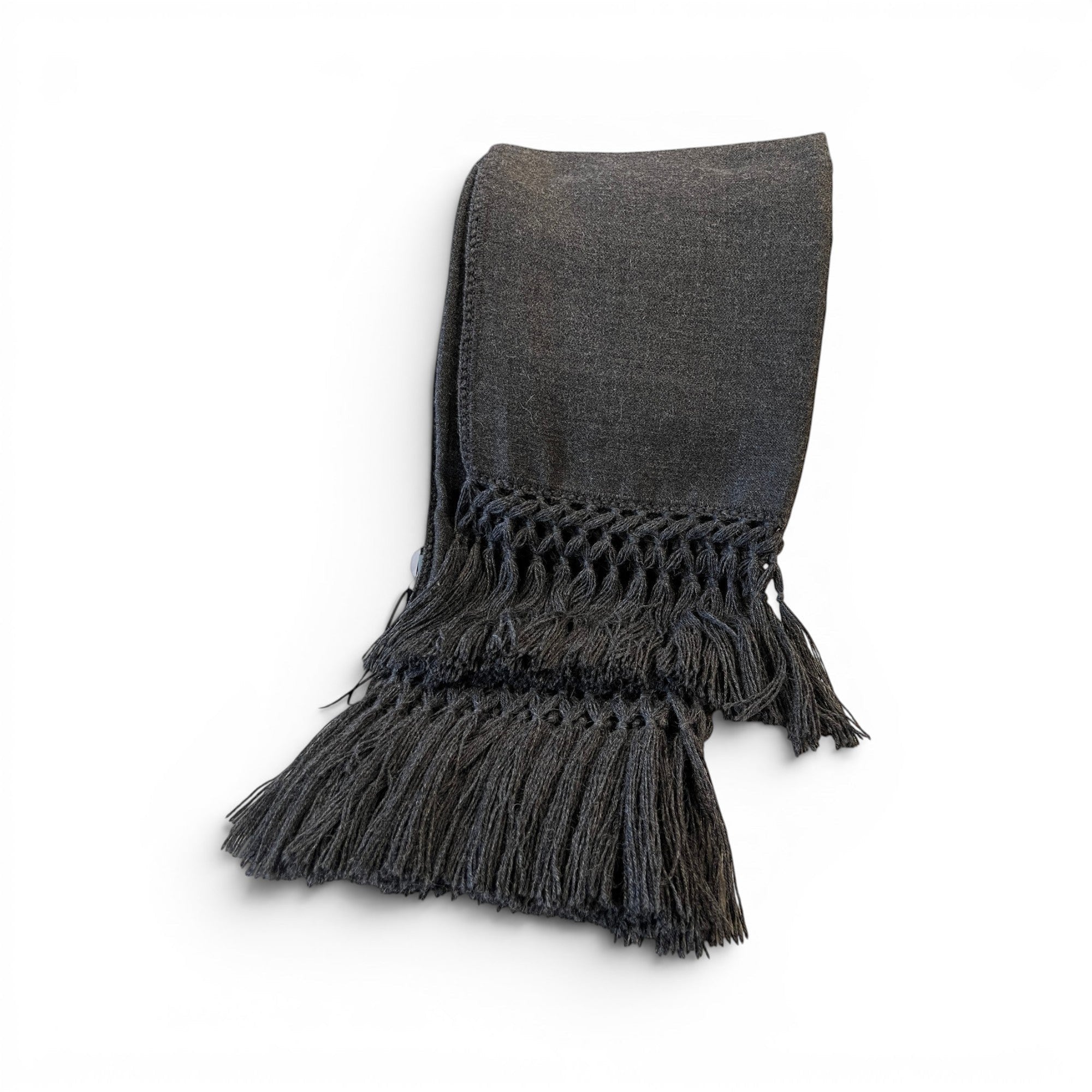 Tara Shaw dark grey alpaca bouclé throw blanket with decorative knotted fringe detail on a white background.