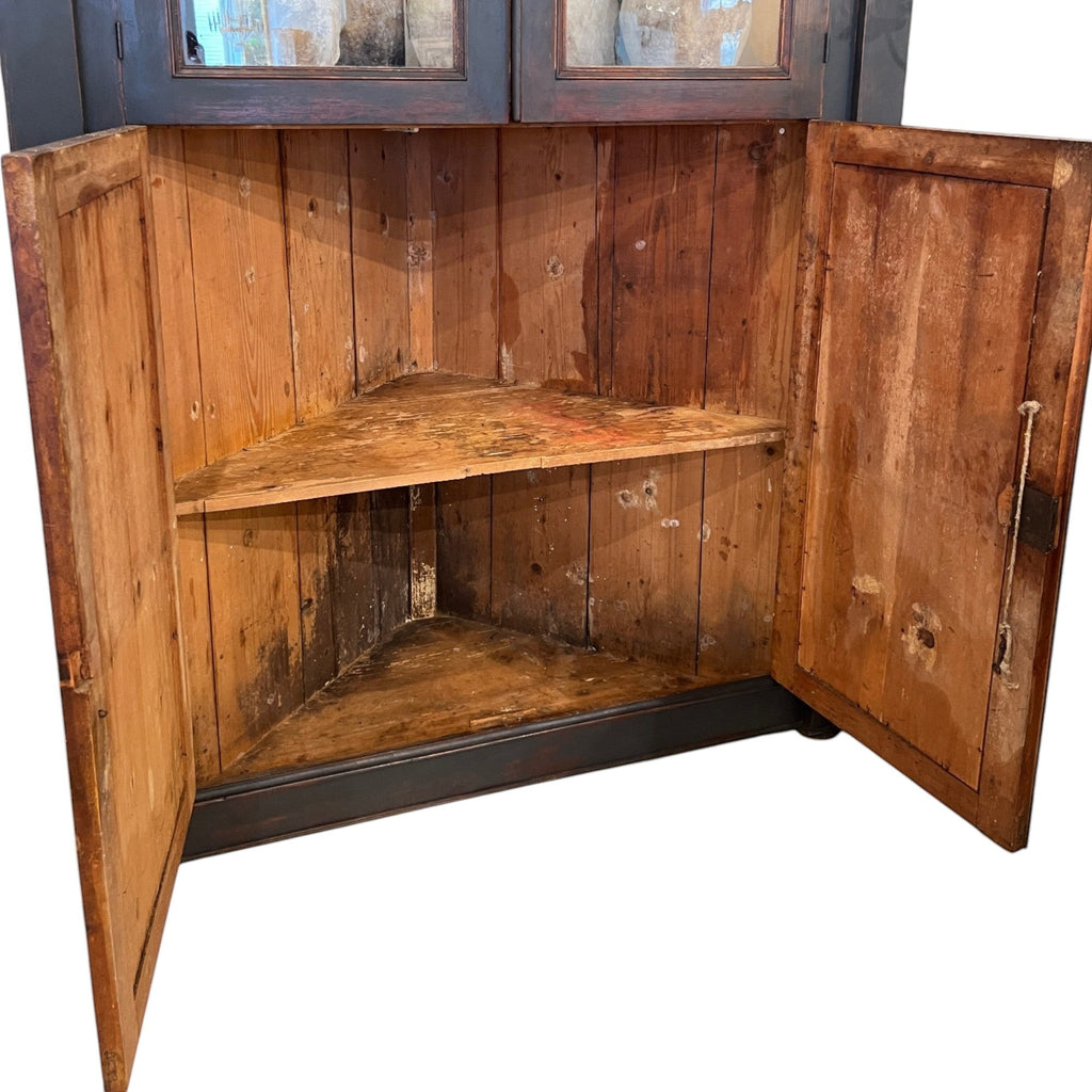 Tara Shaw 18th century Italian ebonized corner cabinet with open wooden interior shelving and aged patina