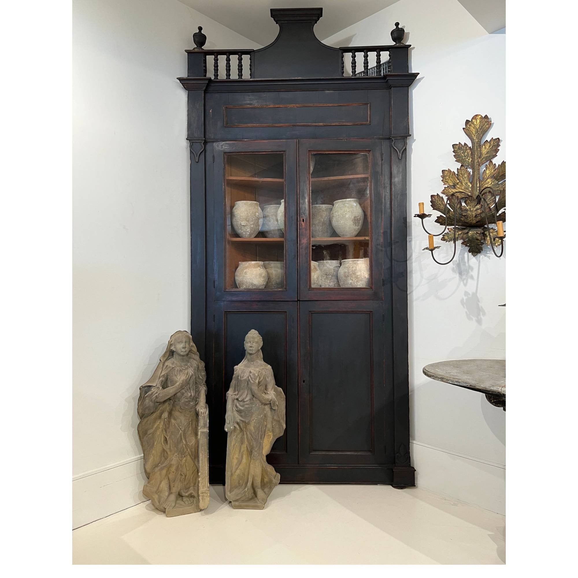 Tara Shaw 18th century Italian ebonized corner cabinet with glass doors and architectural detailing in a room setting