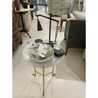 Tara Shaw 19th-century French candleholder with aged patina and metal chain detail on a marble-topped side table.