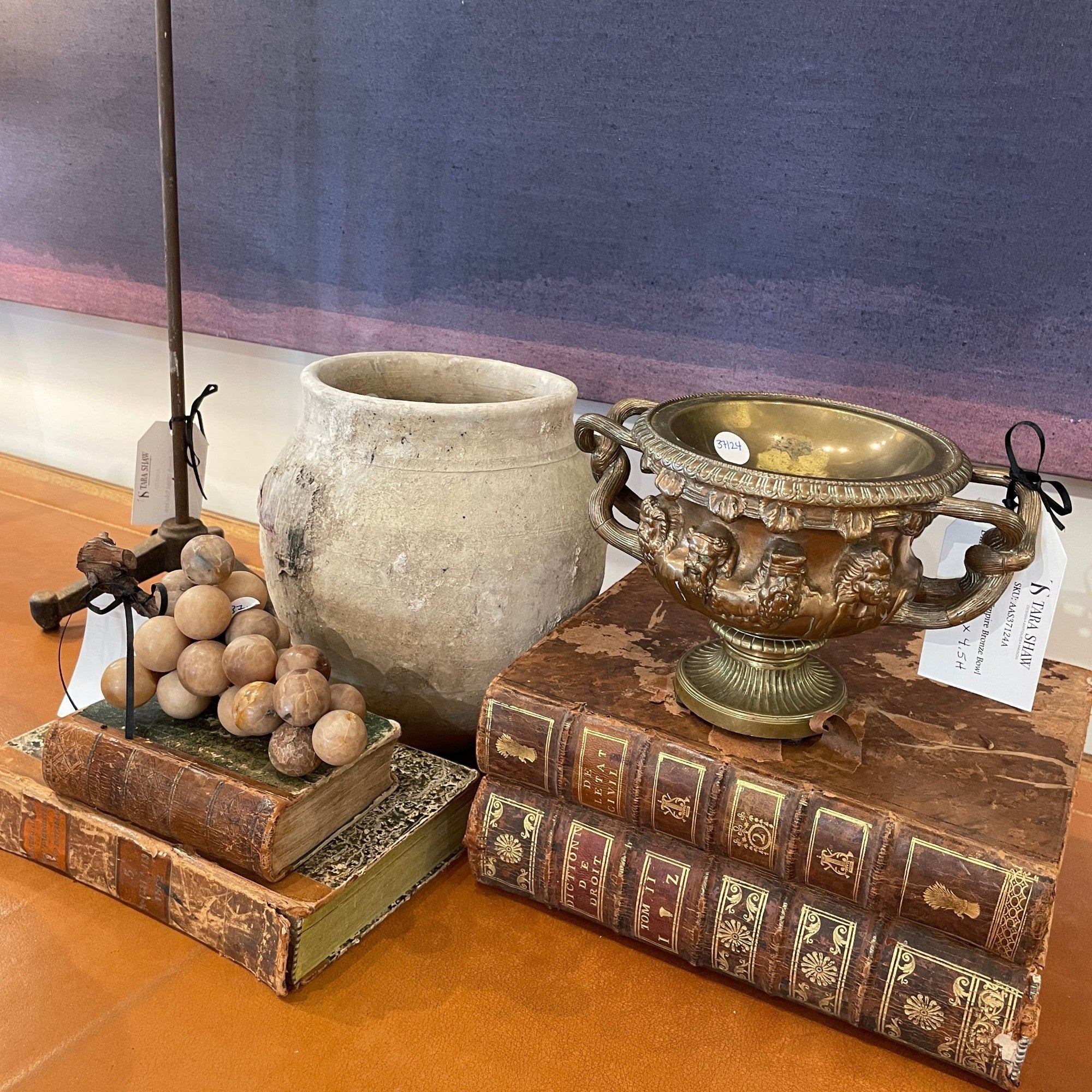 Tara Shaw 19th-century French Second Empire bronze bowl with ornate cast details and aged patina on vintage books.