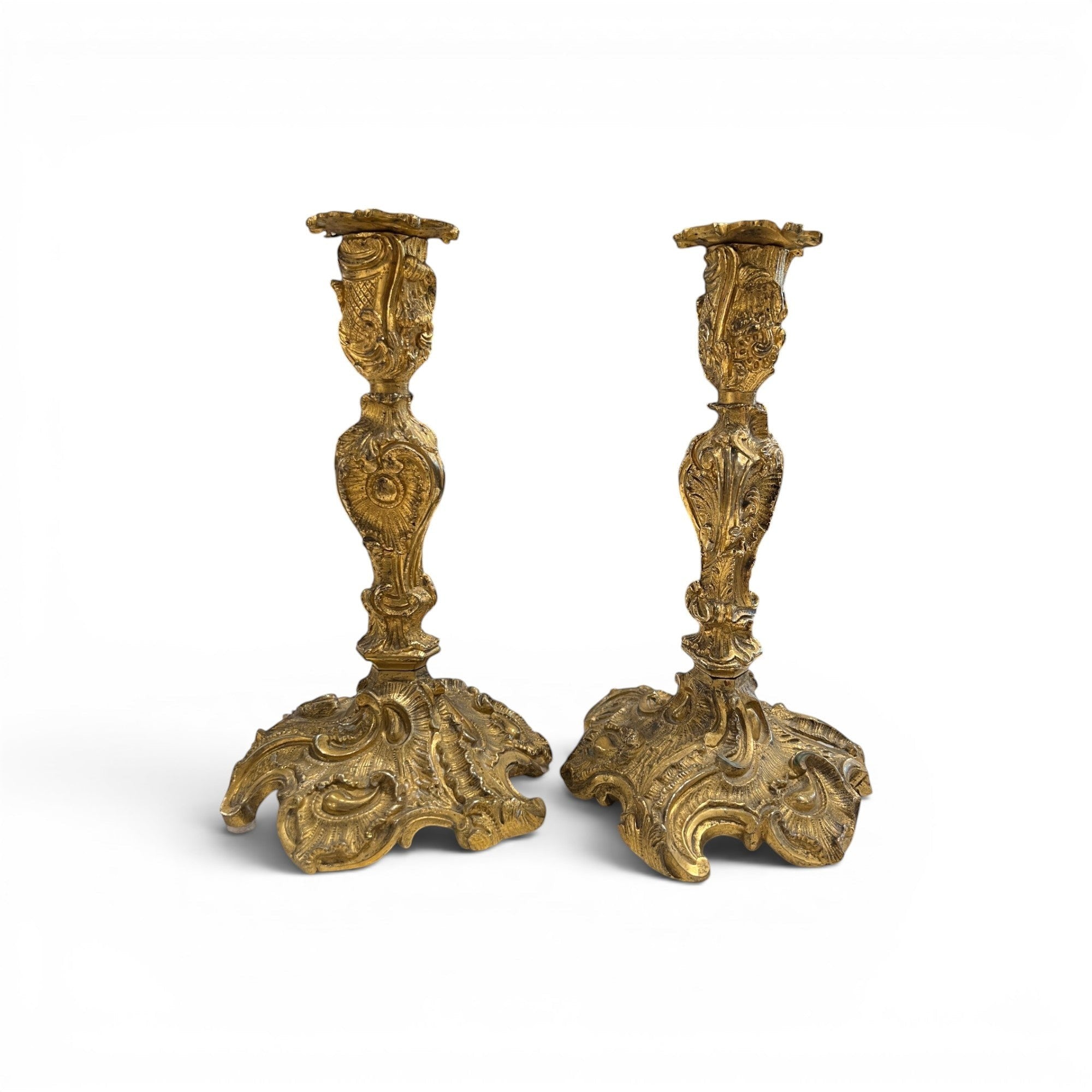 Tara Shaw pair of 19th-century French Louis XV bronze candle holders with intricate rococo detailing and aged patina.