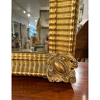Tara Shaw 19th century French Empire mirror with gold ripple frame and detailed medallion corner detail.