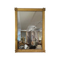Tara Shaw 19th century French Empire mirror with a gold rippled frame and ornate medallion corners.