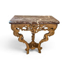Tara Shaw 18th century French gilded console table with intricate carvings, marble top, and ornate hoof feet.