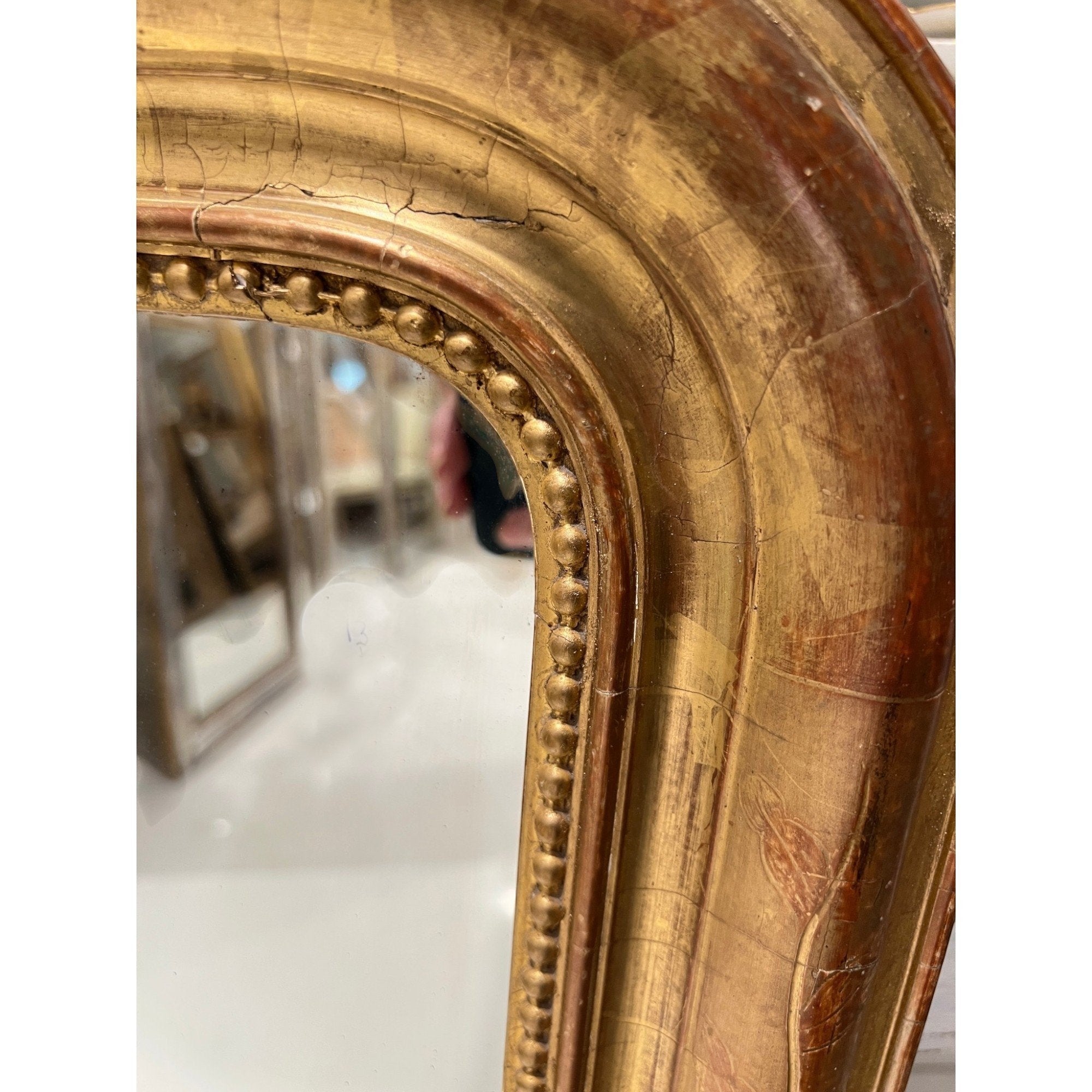 Tara Shaw 19th century French Louis Philippe mirror featuring a curved gilded frame with delicate floral detailing.