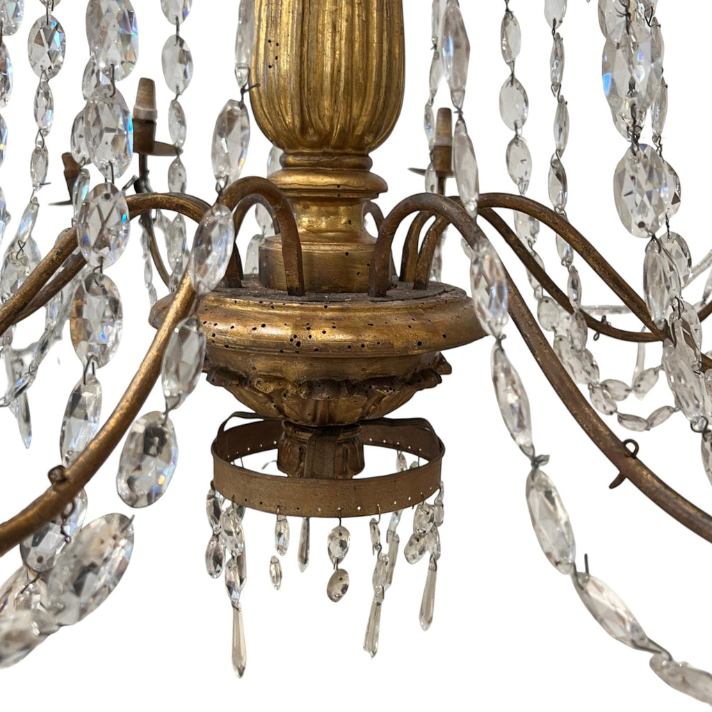 Tara Shaw 18th century Genovese chandelier with aged gold patina, scrolling arms, and cascading crystal pendants.