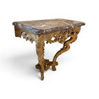 Tara Shaw 18th century French gilded console table with a marble top and ornate carved hoof feet.