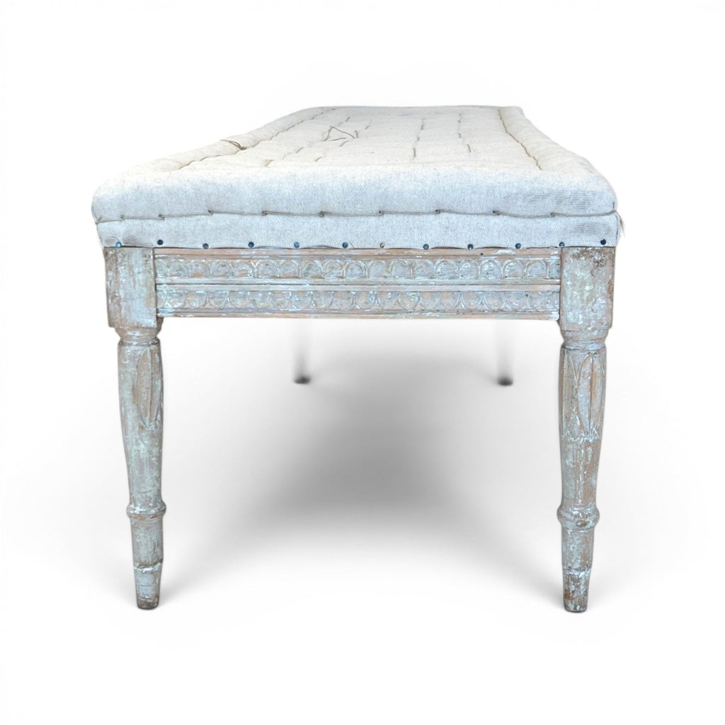 Tara Shaw 19th-century Gustavian backless bench with a tufted cream cushion and distressed light blue wooden frame.