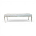 Tara Shaw 19th-century Gustavian backless bench with a tufted light grey upholstered seat and distressed wooden legs.