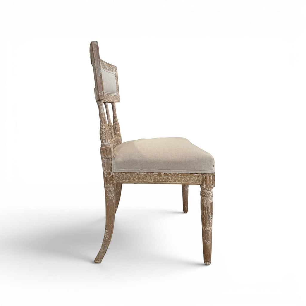 Tara Shaw 18th century Swedish Gustavian chair with distressed wood finish and beige linen upholstered seat, side view.