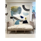 Tara Shaw 18th century Gustavian daybed with carved wood frame, white sheepskin throw, and neutral linen pillow.