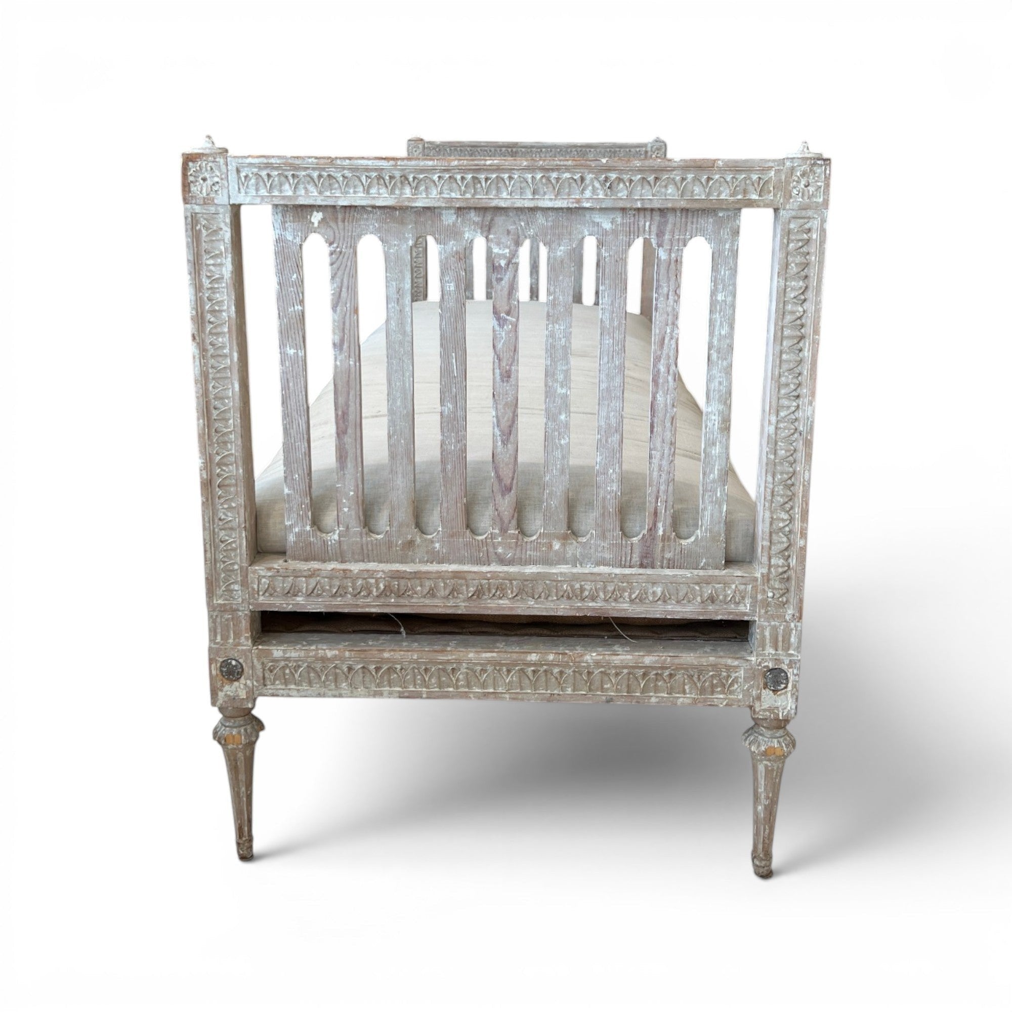 Tara Shaw 18th century Gustavian daybed with carved wood frame, aged patina, and neutral upholstered seat.