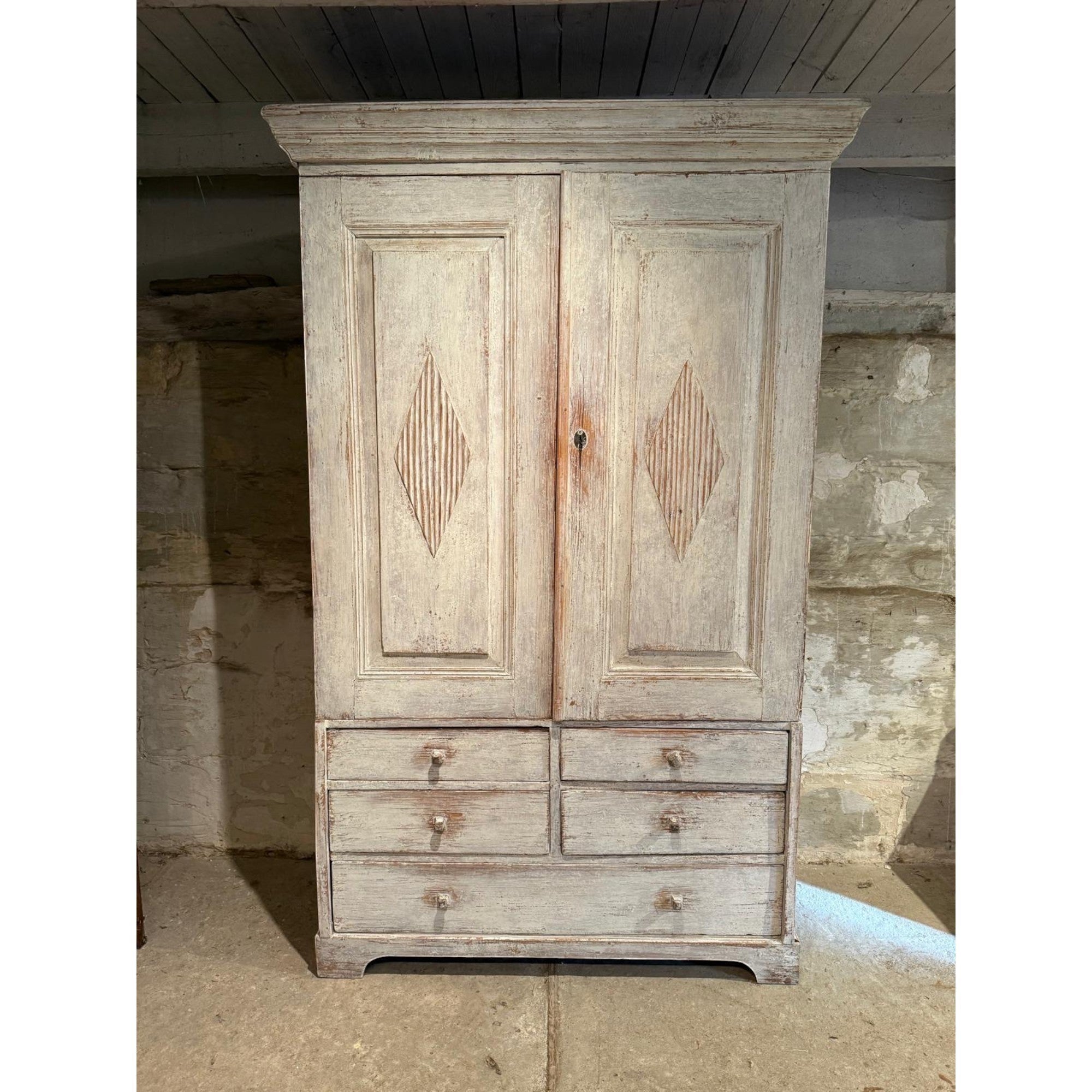 Tara Shaw 18th century Swedish Gustavian cabinet in distressed white paint with reeded diamond door carvings.