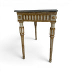 Tara Shaw 18th-century Italian Louis XVI console table with a grey marble top and distressed gold-painted wood frame.