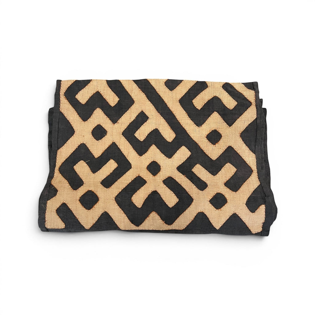 Tara Shaw authentic African Kuba cloth long runner featuring intricate black and beige geometric handwoven patterns.