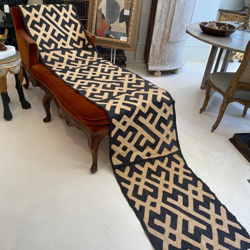 Tara Shaw long runner made of authentic handwoven African Kuba cloth with a bold black and beige geometric pattern.