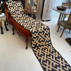 Tara Shaw long runner made of authentic handwoven African Kuba cloth with a bold black and beige geometric pattern.