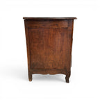 Tara Shaw 18th-century French Louis XV walnut commode side view showing aged wood patina and curved cabriole legs.