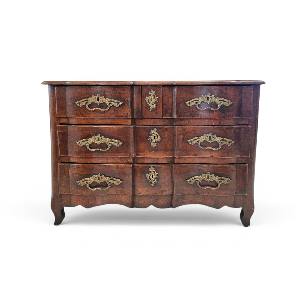 Tara Shaw 18th-century French Louis XV walnut commode featuring curved lines and original ornate bronze hardware.