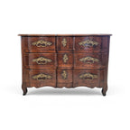 Tara Shaw 18th-century French Louis XV walnut commode featuring curved lines and original ornate bronze hardware.