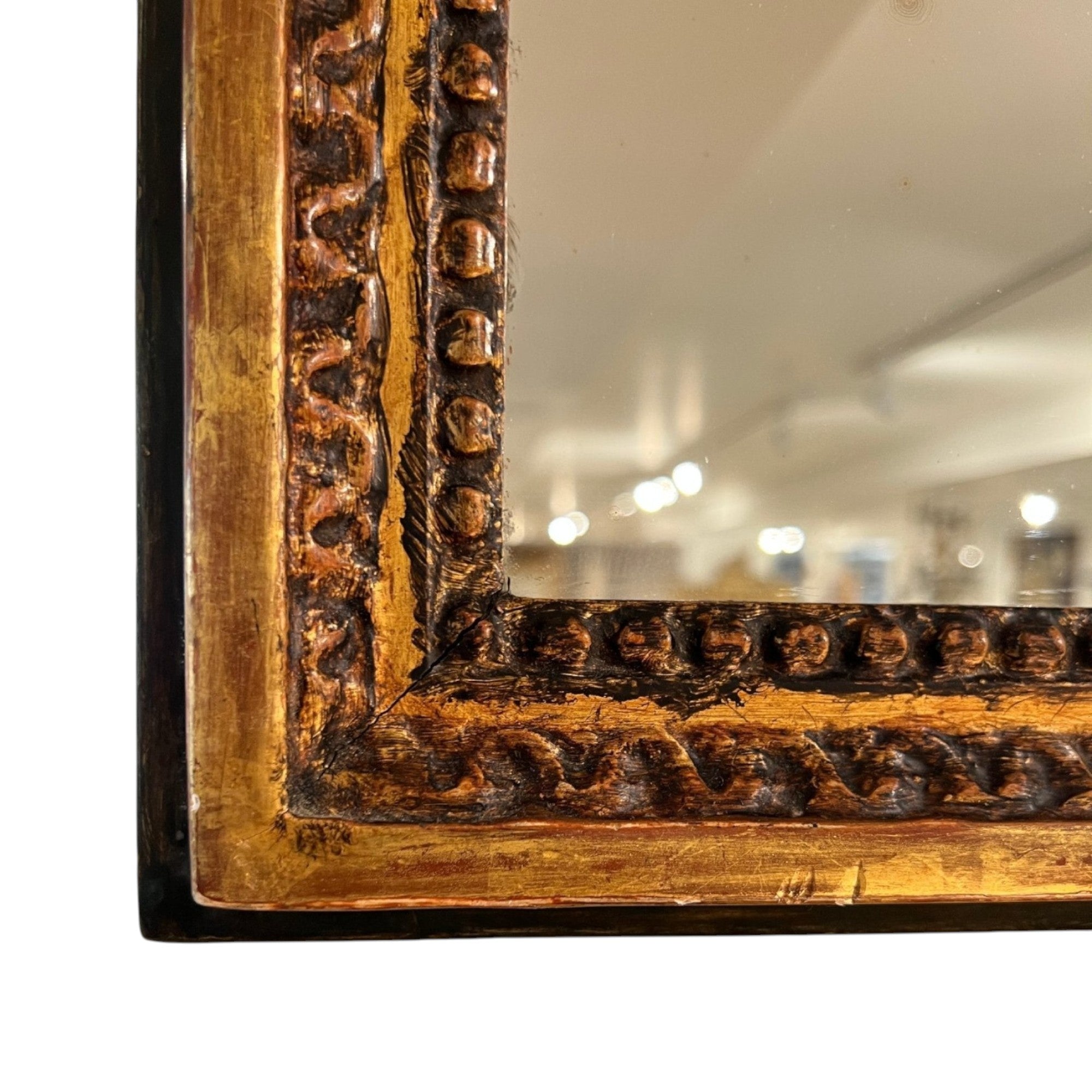 Tara Shaw 18th Century French Louis XVI mirror with a carved, aged gold patina frame and intricate detailing.